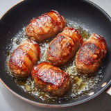 Crépinette de porc à la poêle, une recette savoureuse qui consiste à faire griller des morceaux de viande de porc dans une poêle.